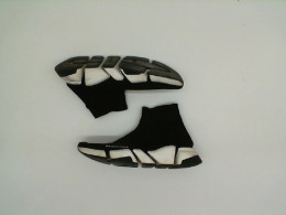 Black sneakers with white soles