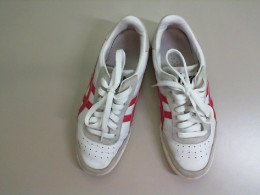 Women's white sneakers with red stripes