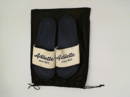 shoes blu&white in a black bag