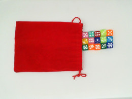 multi-colored dice in a rad bag 