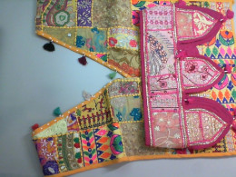 Yellow vest decorated with embroidery + pink belt