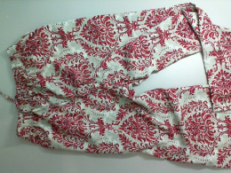 Light-colored pants with a red pattern