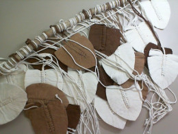 Decorative curtain for the wall made of threads, on a wooden stick