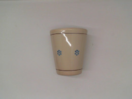 Cream colored ceramic mug with blue pattern