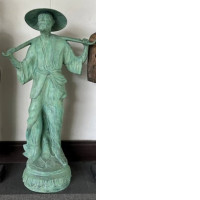 Decorative statue of a man with buckets