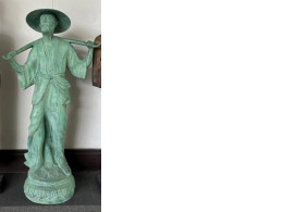 Decorative statue of a man with buckets