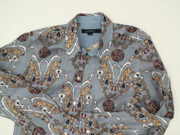 Light blue long-sleeved collared shirt with pattern
