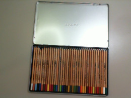 Set of colored pencils in a metal box