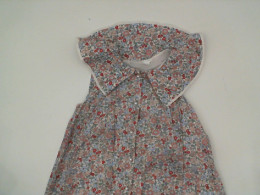 White children's dress with red floral pattern 