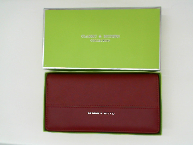 Red women's wallet in a green box Red women's wallet in a green box