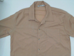 Cream-colored short-sleeved collared shirt Cream-colored short-sleeved collared shirt