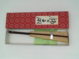 Light green Japanese fan in a red box