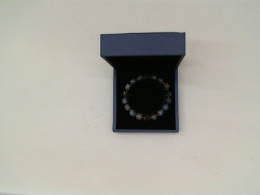 Purple beaded bracelet in a blue box