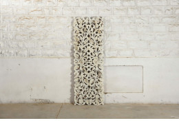 white rectangular wood panels with carvings