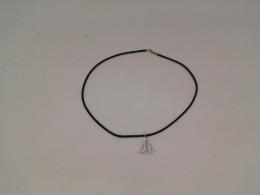 Black necklace with silver triangle pendant
