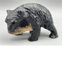 Wooden souvenir figurine of a bear with a fish