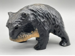 Wooden souvenir figurine of a bear with a fish