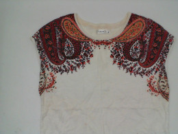 White sleeveless shirt with red pattern White sleeveless shirt with red pattern