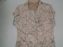 Women's cream colored suit with black pattern 