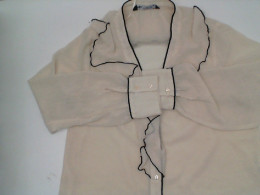 Women's cream-colored, long-sleeved, V-neck shirt with black stripes 