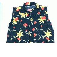 Black sleeveless zip-up collar top with yellow floral pattern Black sleeveless zip-up collar top with yellow floral pattern