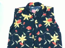 Black sleeveless zip-up collar top with yellow floral pattern Black sleeveless zip-up collar top with yellow floral pattern