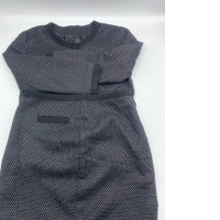 Women's long-sleeved round-neck shirt with buttons and a black short skirt with white polka dots 