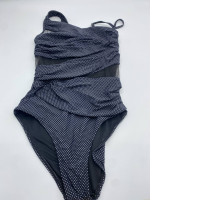 Women's black swimsuit with white polka dots 