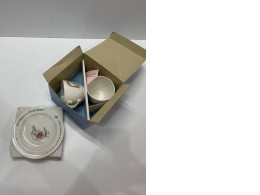 Set of teacups and plate with rabbit print