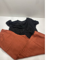 Women's suit: orange pants and black t-shirt