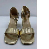 Gold women's hilled shoes