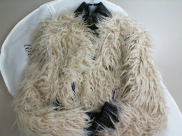Women's short jacket with fur in a cover on a hanger Women's short jacket with fur in a cover on a hanger