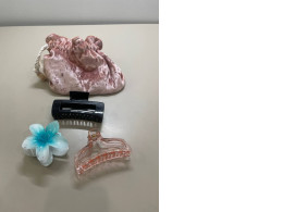 set of three hair clips and a bag for them