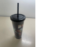Plastic cup with a straw