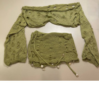 set of a short sweater and skirt with decorative plastic buttons in the form of shells