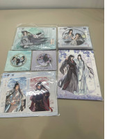 A gift set that includes a collection of character figurines, two postcards, a set of stickers, two badges, and a poster.