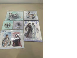 A gift set that includes a collection of character figurines, two postcards, a set of stickers, two badges, and a poster.