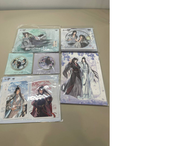 A gift set that includes a collection of character figurines, two postcards, a set of stickers, two badges, and a poster. A gift set that includes a collection of character figurines, two postcards, a set of stickers, two badges, and a poster.