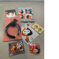 A large gift set that includes a raincoat, four hairpins, two keychains, a toy, a hair band, and a hair elastic