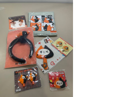 A large gift set that includes a raincoat, four hairpins, two keychains, a toy, a hair band, and a hair elastic