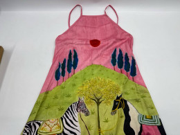 Women's long dress with a light brown tank top and horse pattern