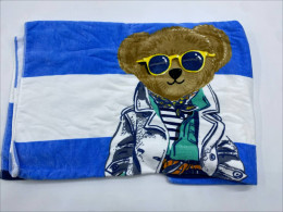 Blue towel with white stripes and a bear pattern 