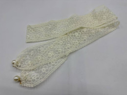 Cream colored neckerchief with bell 
