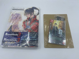 Set of artbook and nintendo switch cartrige and keychain Set of artbook and nintendo switch cartrige and keychain