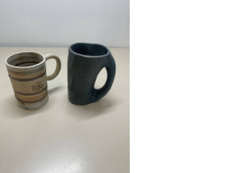 a set of two decorative mugs
