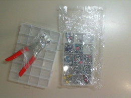 A set of 2 plastic containers + a special gun for riveting clothes and a set of riveting pins in different colors