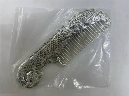 Silver stainless steel comb with koi fish pattern Silver stainless steel comb with koi fish pattern