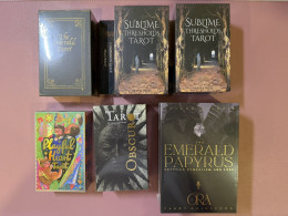 Set of 7 Sublime Thresholds Tarot, Emerald Tarot, Playful Heart Tarot Obscuro Tarot by Lotta Glybotskaia Emerald Papyrus Tarot, and Ora Tarot Guidebook