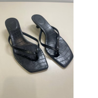 Women's black open toe flip flops with a small heel