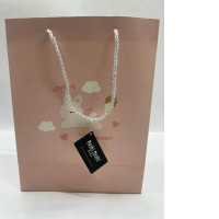 pink paper gift bag from the brand Moshi Moshi, featuring a "Lovely Bunny" design. 